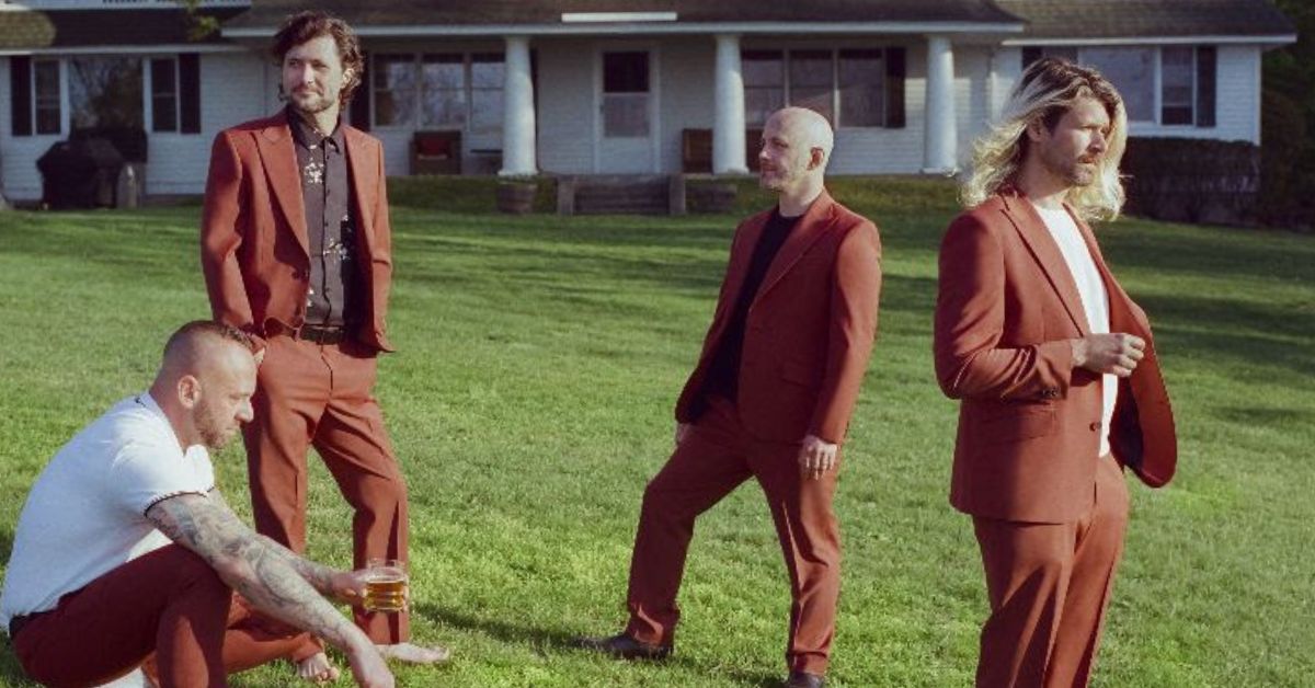 A photo of Taking Back Sunday standing on the lawn of a suburban NY house Photo credit: DJay Brawner