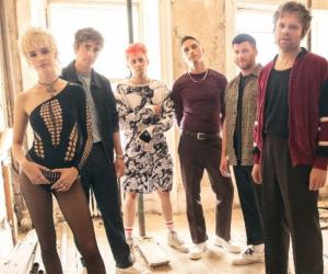 A photo of Enter Shikari and Wargasm standing in a room.