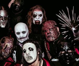 Photo of Slipknot wearing masks against a black background
