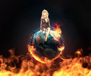 Dolly Parton sitting on top of the world with a fire below