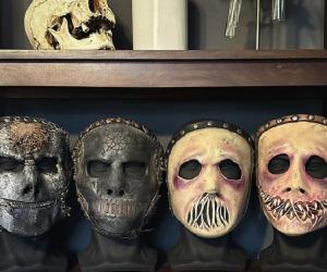 The four masks Jay Weinberg wore in Slipknot displayed on a shelf. 